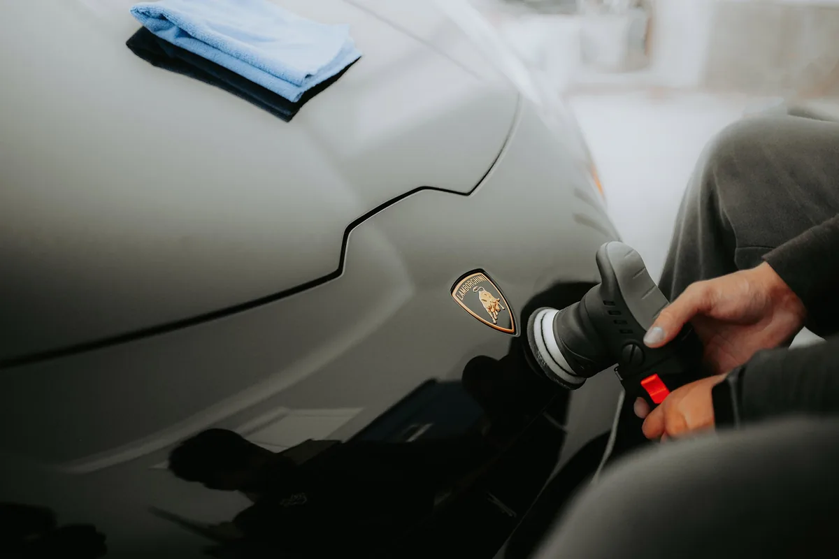 Machine polisher being used on a painted panel